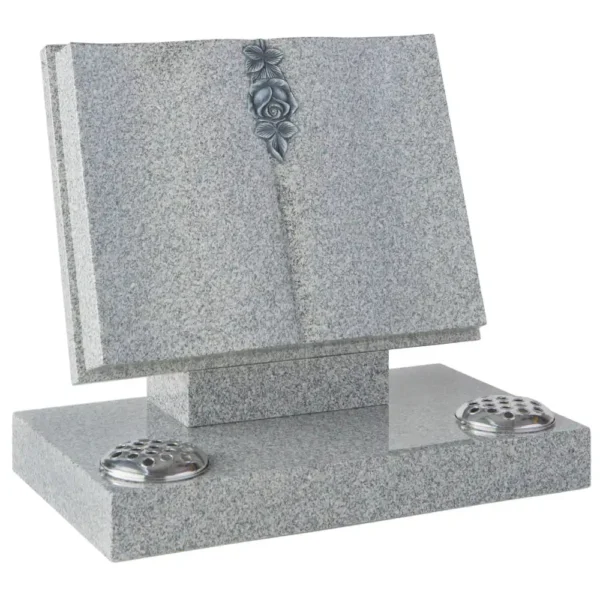 Book memorial with a V Centre and shaped pages with a carved and highlighted rose sitting on an angle on a tick rest with a rectangular base with a two flower holes