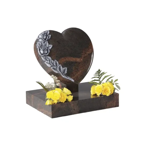 Heart shaped memorial sitting on an angle on a tick rest and rectangular base with raised carved and highlighted roses.