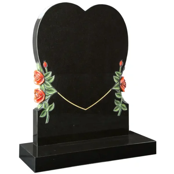 Heart shaped lawn memorial with carved and painted roses to sides with a rectangular base.